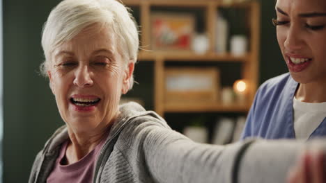 senior woman receiving physical therapy from caregiver