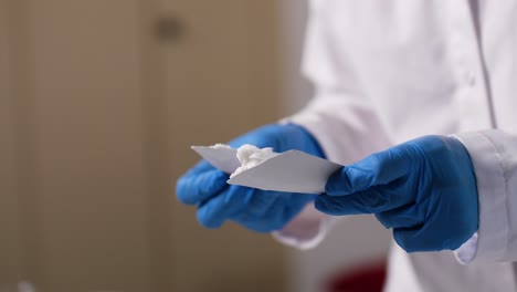 a freshly mixed cream is smeared on a white card in a laboratory