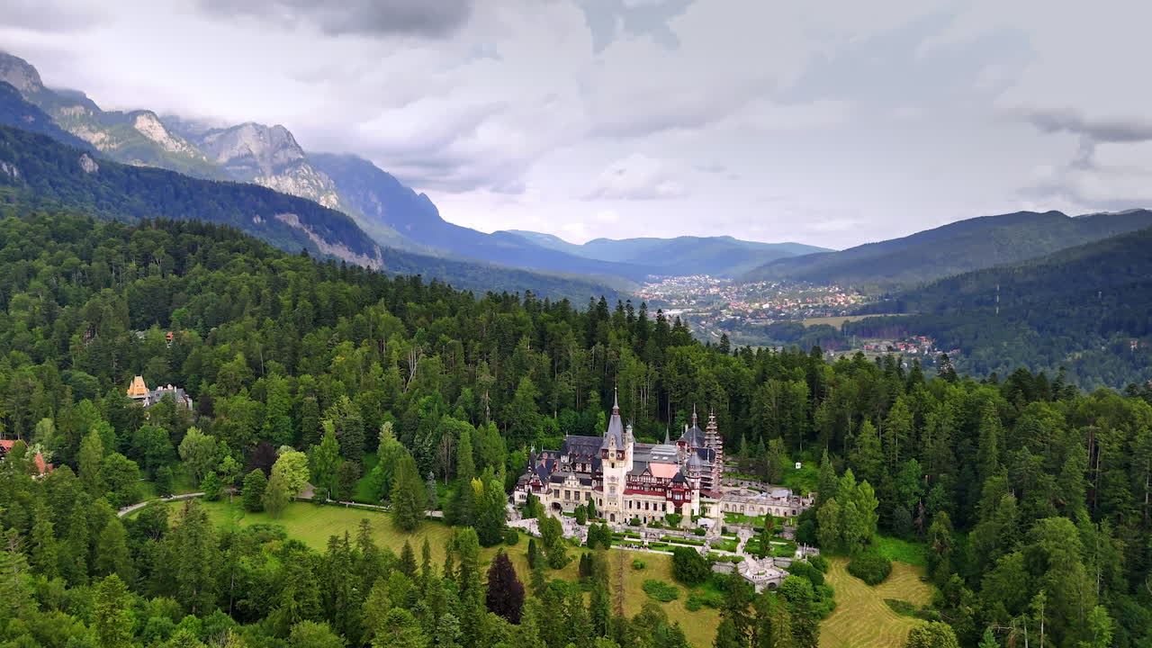 Popular tourist destination located in the evergreen woods. Drone flight near the Pele? Castle in the Carpathian Mountains, Romania