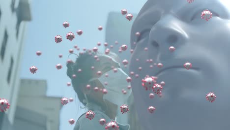 안면 마스크를 착용한 아시아 여성에 대한 인간의 얼굴 모델 위에 떠다니는 다수의 코로나19 세포