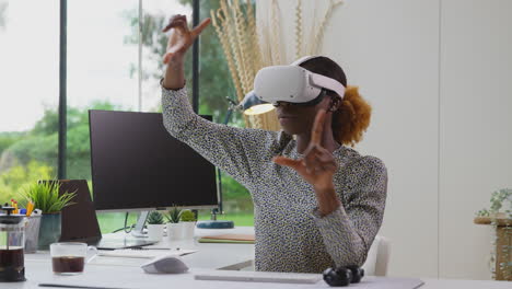 woman working from home office at desk wearing vr headset interacting with ar technology