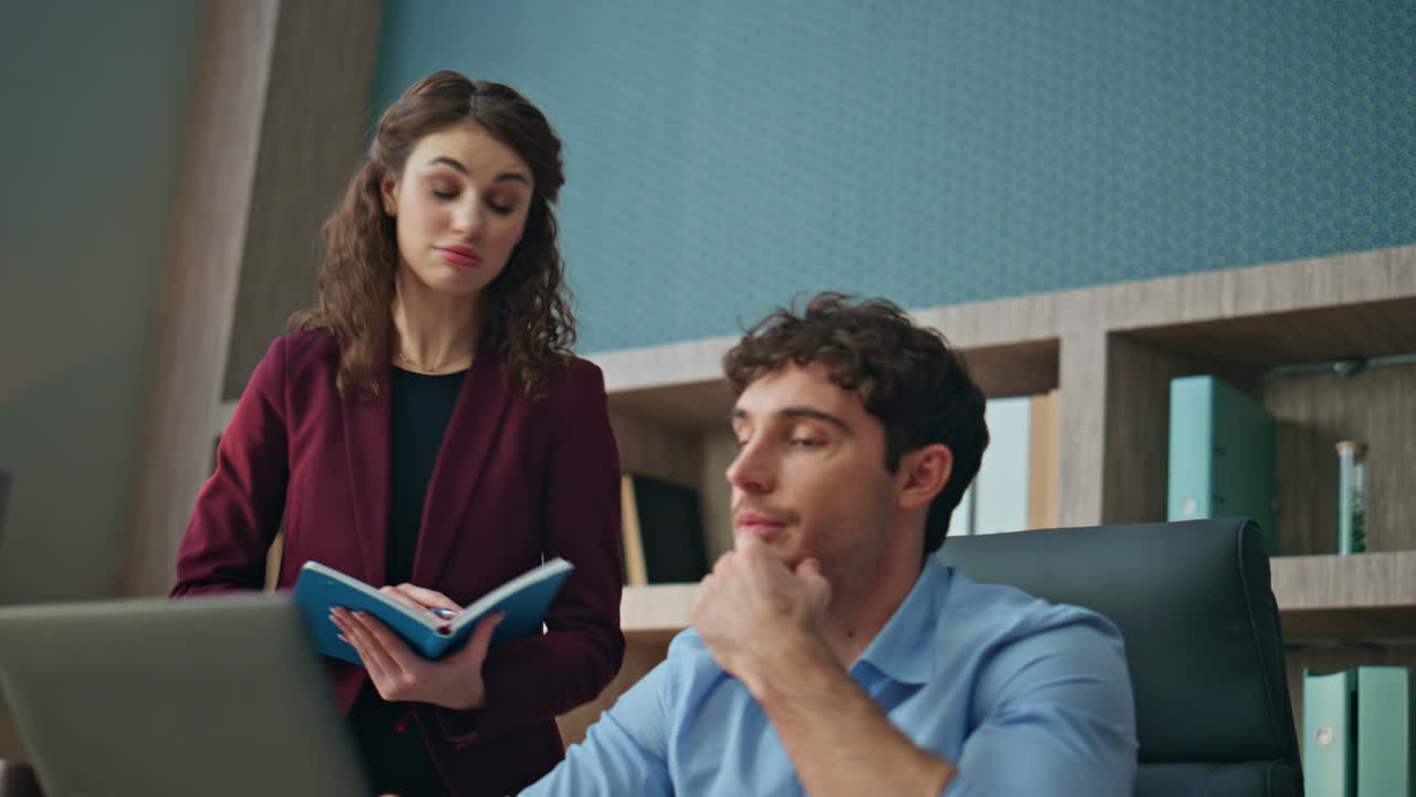 Two colleagues thinking project in workplace closeup. Businesswoman making notes