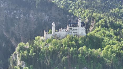 neuschwanstein castle nestled among mountains and forests