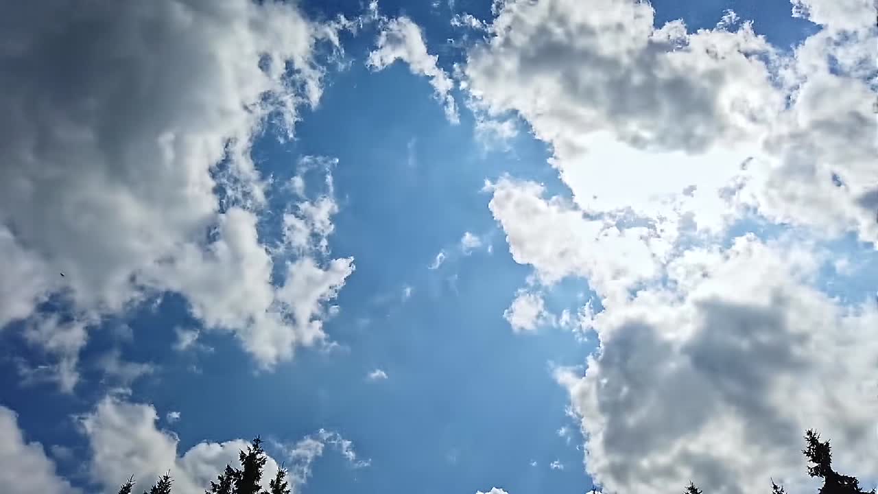 Timelapse of the blue sky with moving clouds. Sunny day
