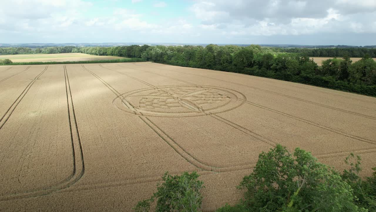Aerial view flying over idyllic Hampshire countryside towards South Wonston 2023 crop circle pattern