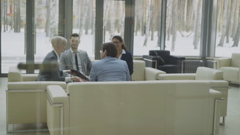 business meeting in modern office lobby