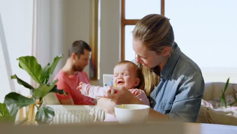 Baby-boy-crying-while-mother-feeding-him-food-4k