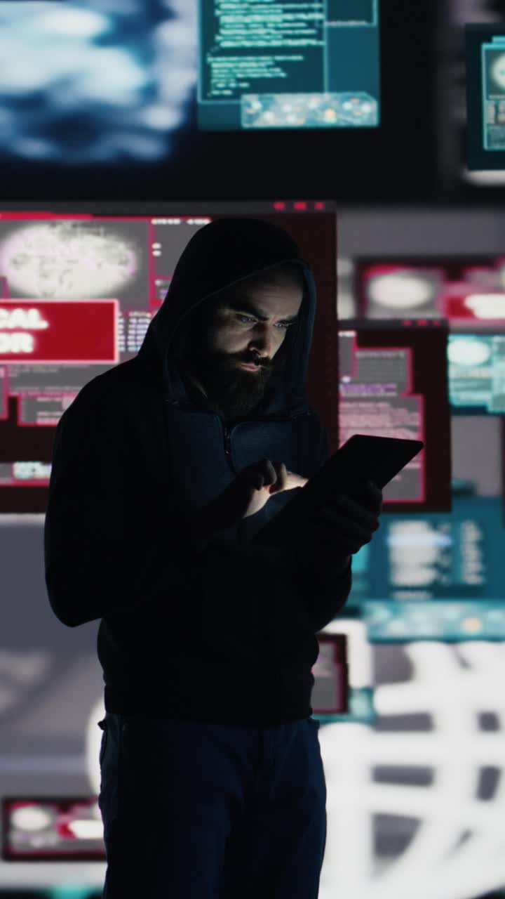 Vertical Video Male hacker breaking into a system in stealth mode by programming code