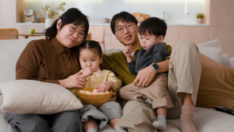 family watching movie with popcorn
