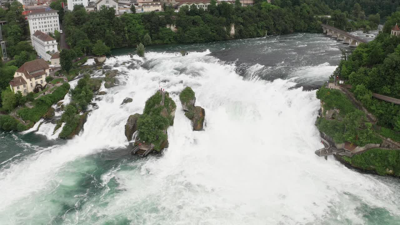 Powerful aerial view of the Rhine Falls cascading through rocky terrain