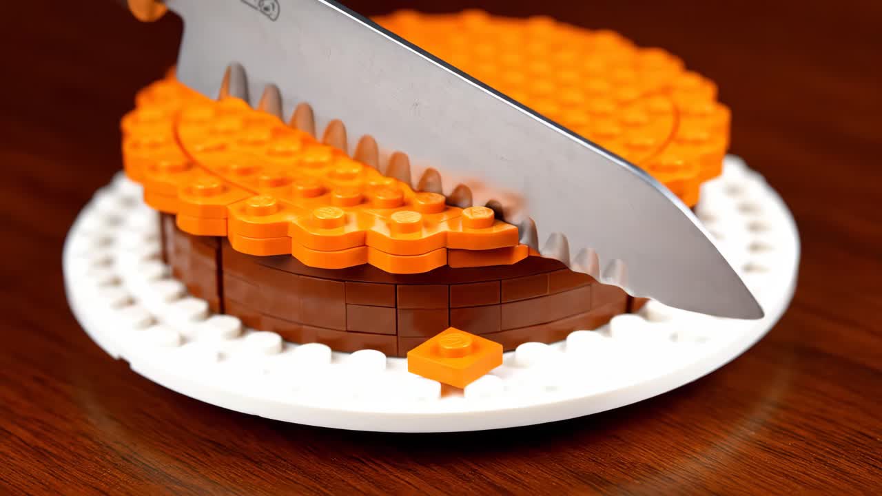 Lego cake being cut with a knife