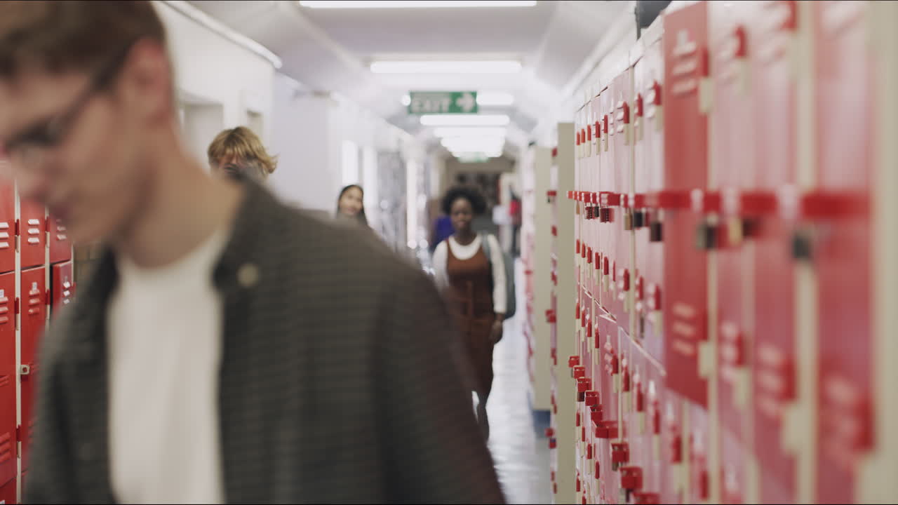 Student in school hallway using phone