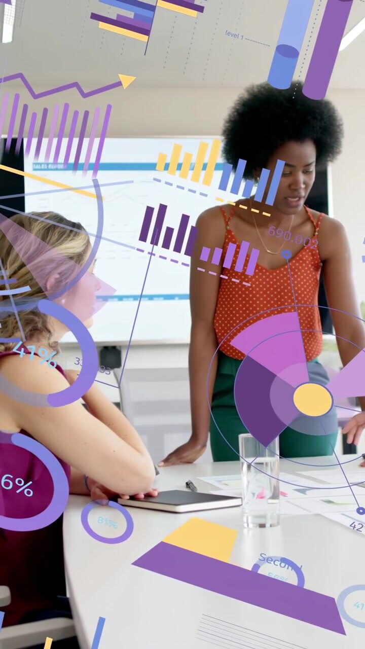 Vertical video: Team lead leaning and pointing causing AR charts growing over table for data review