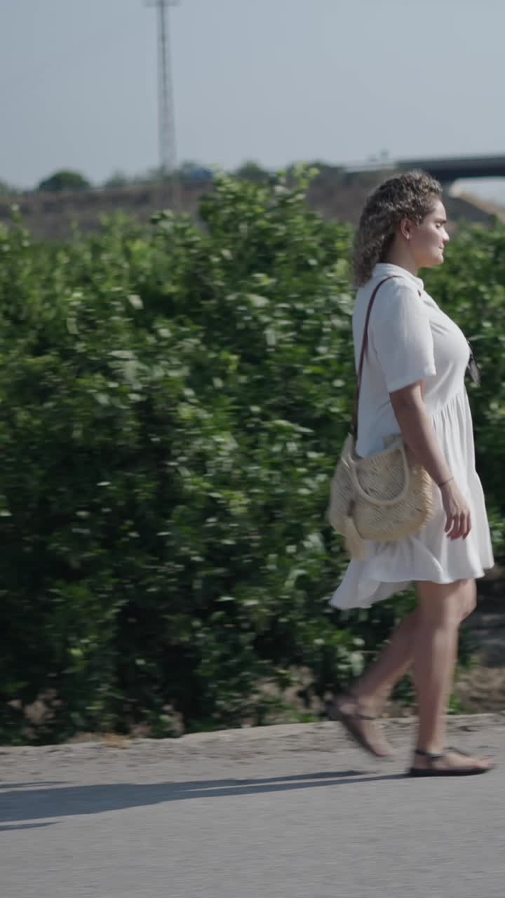 Woman Walking on Road