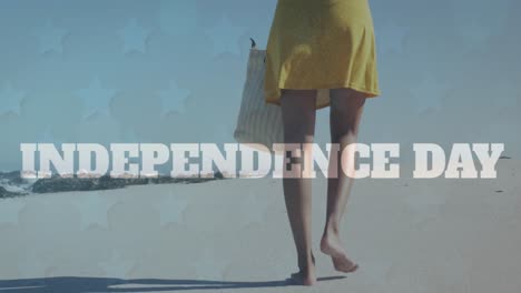 animation of independence text banner over low section of a woman walking at the beach