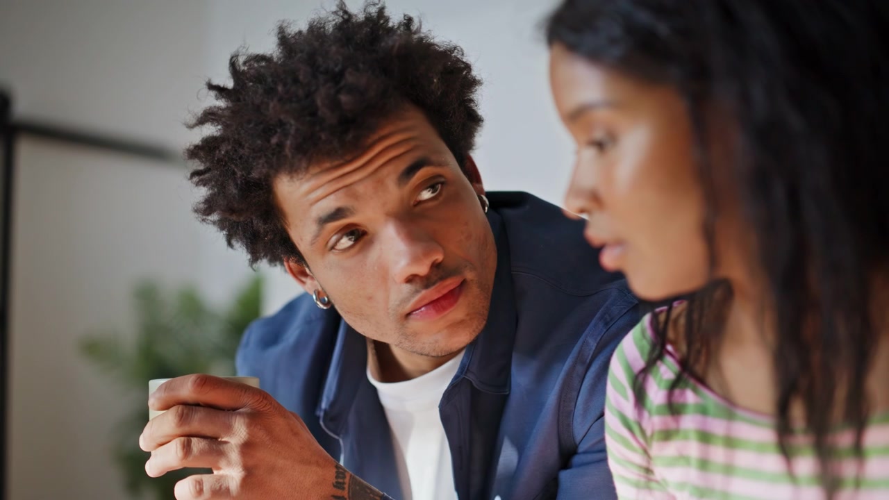 Relaxed spouses watching laptop screen home breakfast in modern kitchen closeup