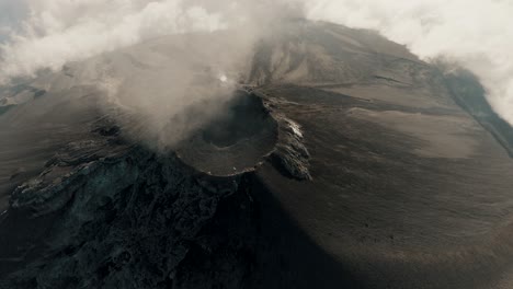 steam rising over crater of fuego volcano in guatemala