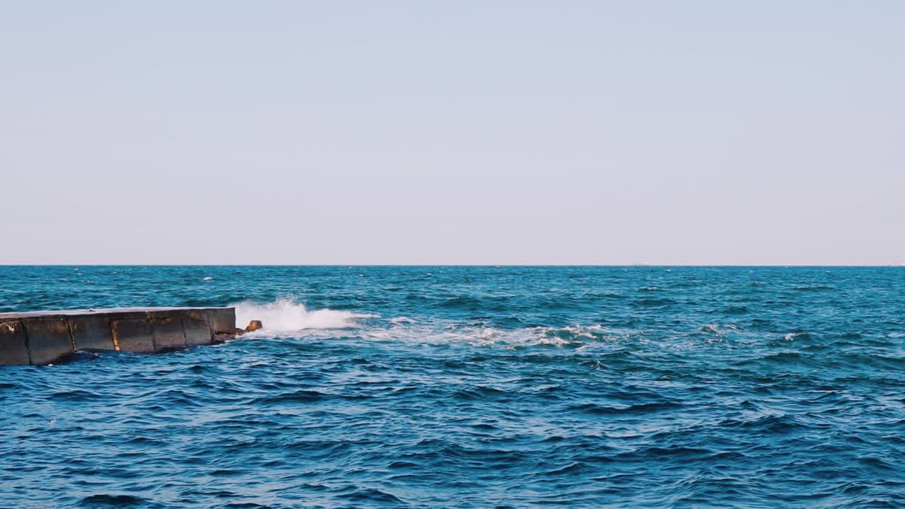 Breaking sea wave. Seascape with wide horizon of the sky and the sea