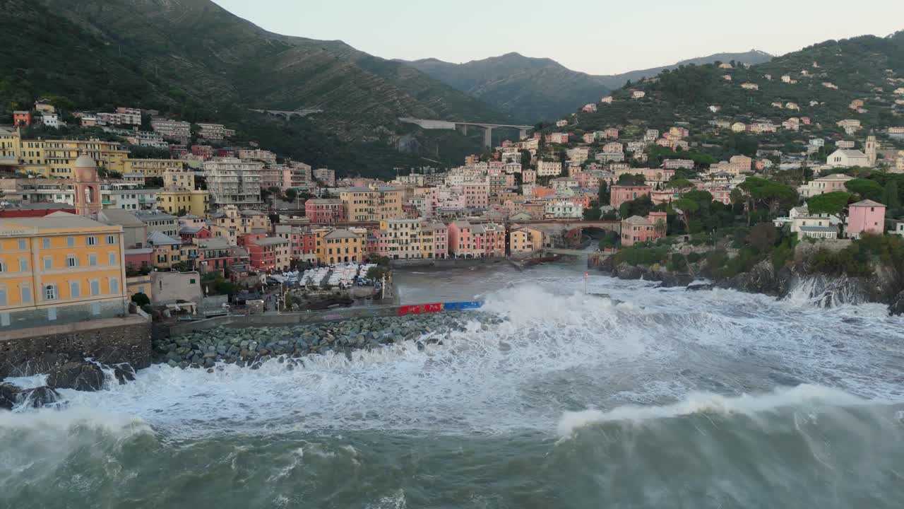 Forceful sea waves breaking on harbor pier on shore of Genoa city