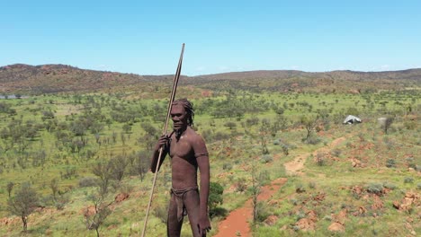 Excellent-Aerial-Shot-Of-A-Statue-Of-An-Aboriginal-Man-In-The-Countryside-Of-Aileron,-Australia