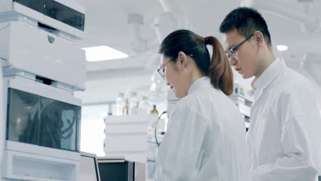 medical biotechnology scientist performing biological experiment on cell culture essay in a sterile environment of designated biosafety laboratory at research facility.