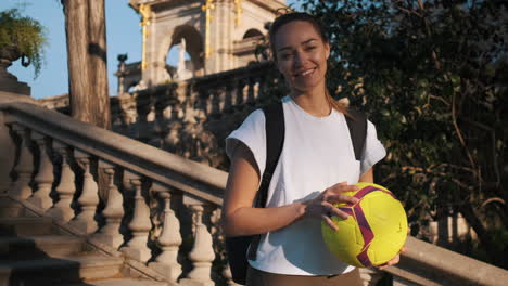 Camera-zooming-on-soccer-woman-smiling-at-camera-in-the-street.