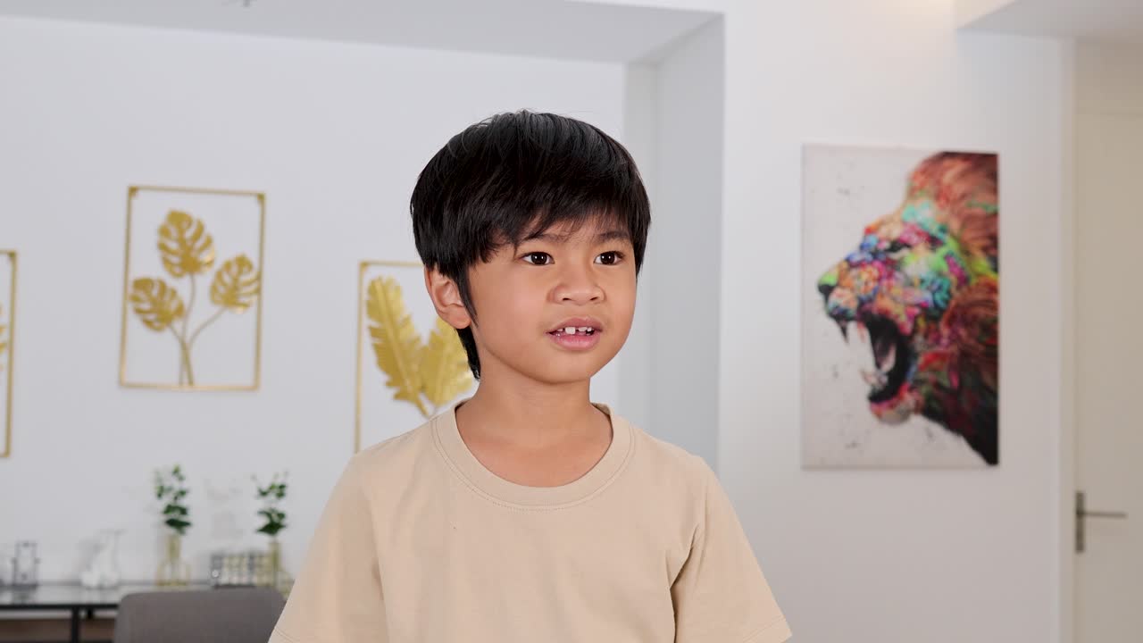 Child covers face with hand, simulating headache, in brightly lit, contemporary home interior