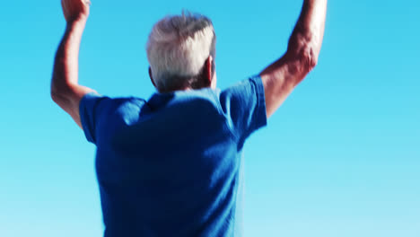 Senior-man-walking-with-american-flag-at-the-beach