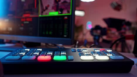 hand operating a video production switcher for live streaming