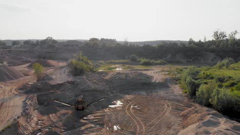 Aerial-dolly-shot-from-a-drone-of-quarry-and-heavy-machinery-in-pomeranian-district-in-Poland