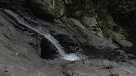 Water-Falling-At-Currumbin-Rock-Pools---Currumbin-Valley,-Queensland,-Australia---static-shot