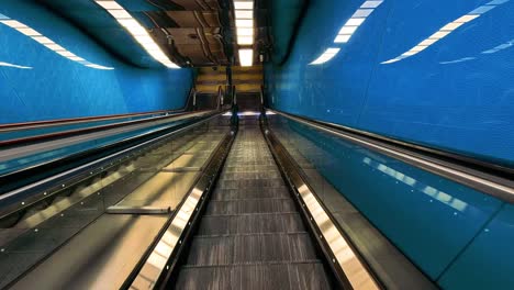 moving through a vibrant blue subway tunnel