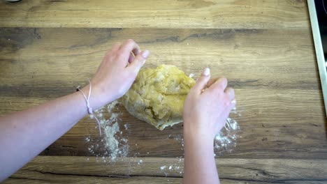 woman dough kneading on a kitchen counter