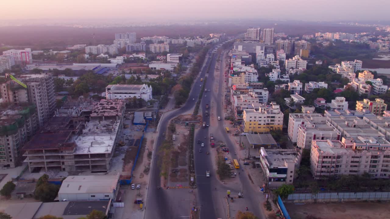 National Highway 44 with under construction buildings and Good Shepherd Church at jeedimetla village, suchitra, hyderabad, telangana, india. day time, zoom in, drone shot, 4k.
