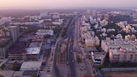 national highway 44 with under construction buildings and good shepherd church at jeedimetla village, suchitra, hyderabad, telangana, india. day time, zoom in, drone shot, 4k.