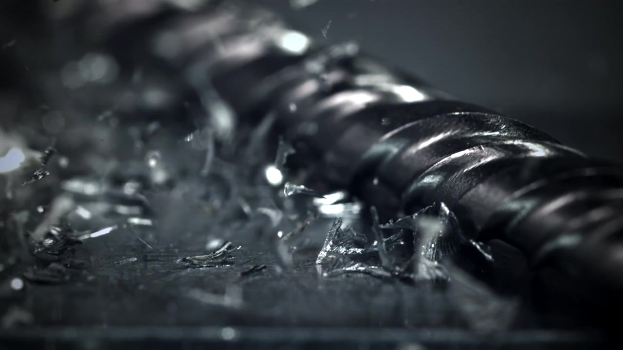 Slow Motion Close-up of Metal Shavings Falling on Industrial Surface