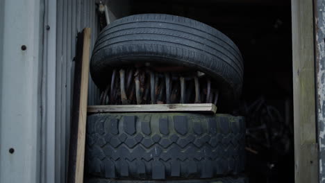 handheld tires piled up in doorway with steel coil