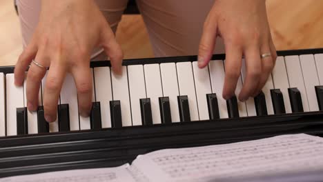 Mujer-Tocando-El-Piano-Con-Anillo-De-Bodas,-Vista-De-Cerca-De-Arriba-Hacia-Abajo-De-Los-Dedos-En-Las-Teclas-En-Cámara-Lenta