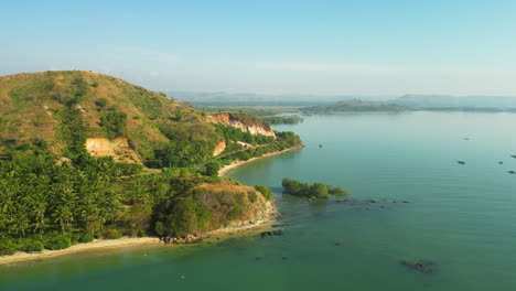 drone fly above lombok island indonesia coastline with stunning cliff and ocean view