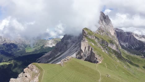 drone shot of idyllic mountain range in puez odle national park of dolomites during cloudy day - orbiting shot