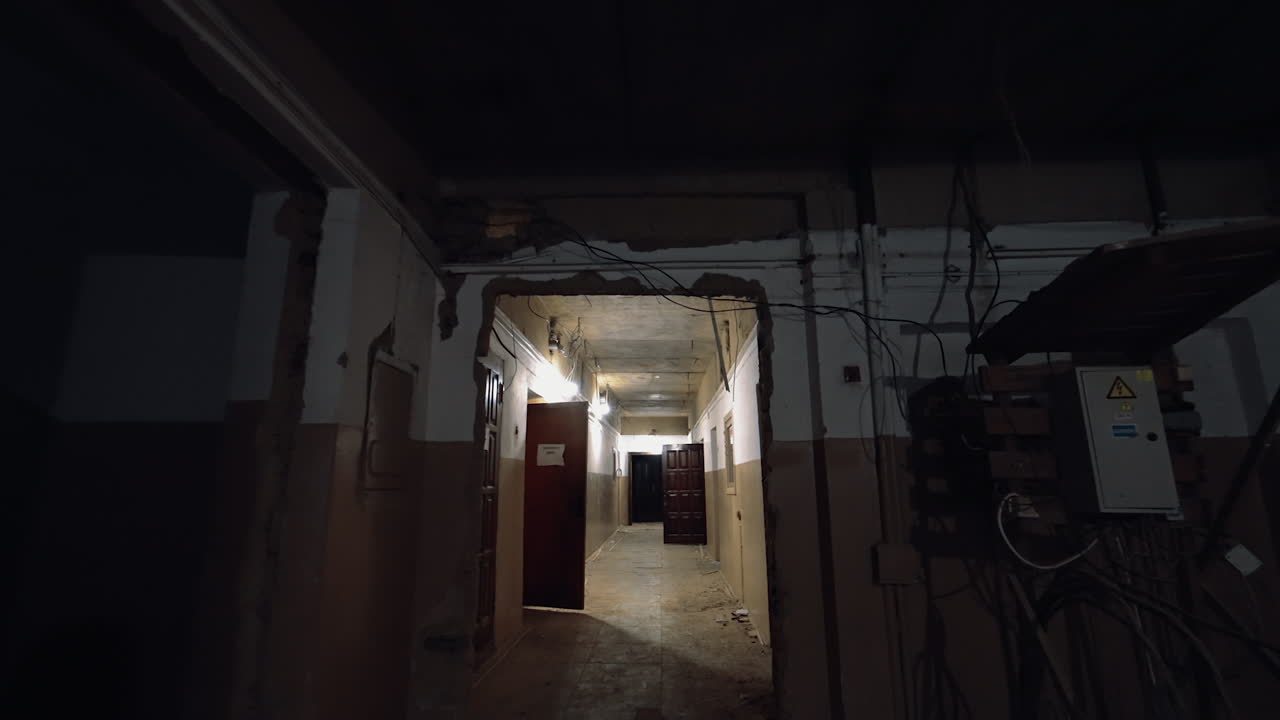 Entering the corridor of the old building with the doors open to the rooms or no doors at all. Reconstruction concept.