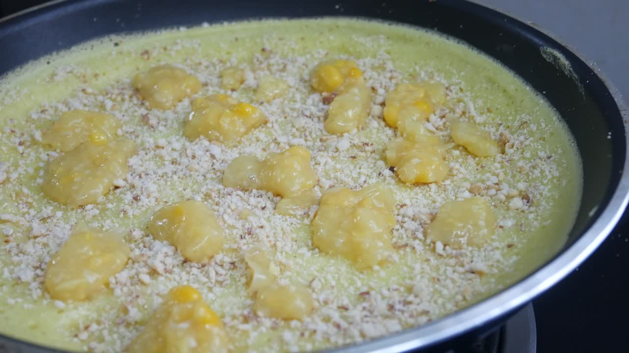 Apam balik or Malaysian Peanut Pancake turnover.  Flour pancake stuffed with sugar and corn topping. Cooked using the hot pan. Famous street food in Malaysia