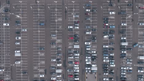 aerial: crowded parking lot with standing automobiles