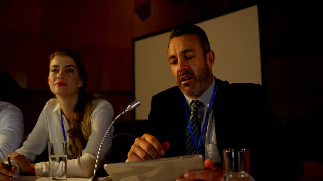 un hombre de negocios caucásico maduro habla en un seminario de negocios en el auditorio 4k.