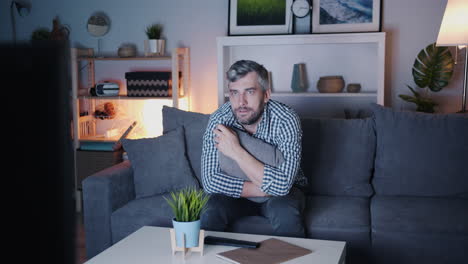 man watching tv at night