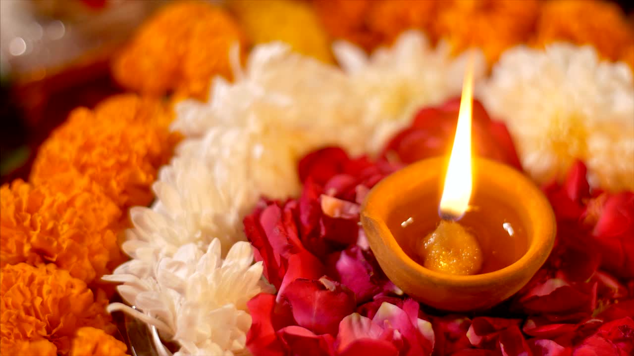 Diwali diya on a colorful background with different colorful flowers