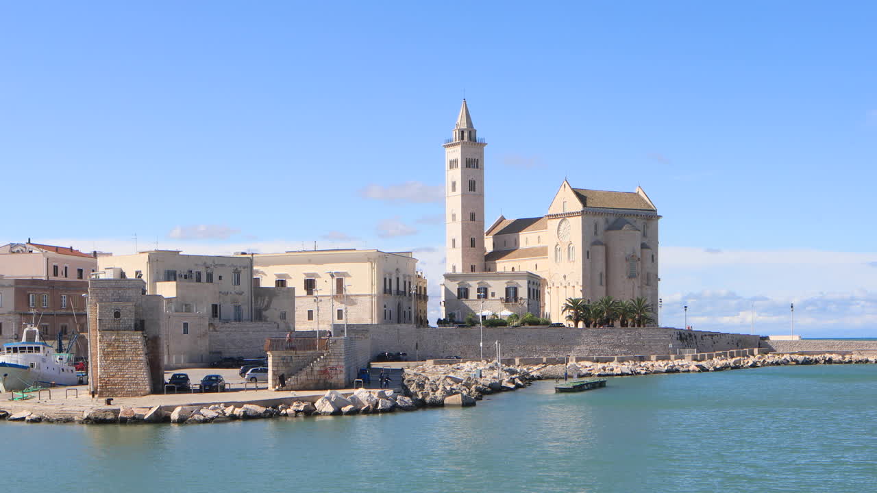 Looking across the port of Trani towards the cathedral. Dediated to Saint Nicholas the Pilgrim, Trani cathedral was consecrated in 1143 and is a fine example of Apulian Romanesque architecture.