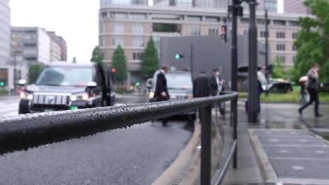 walking people on the street in marunouchi tokyo rainy day