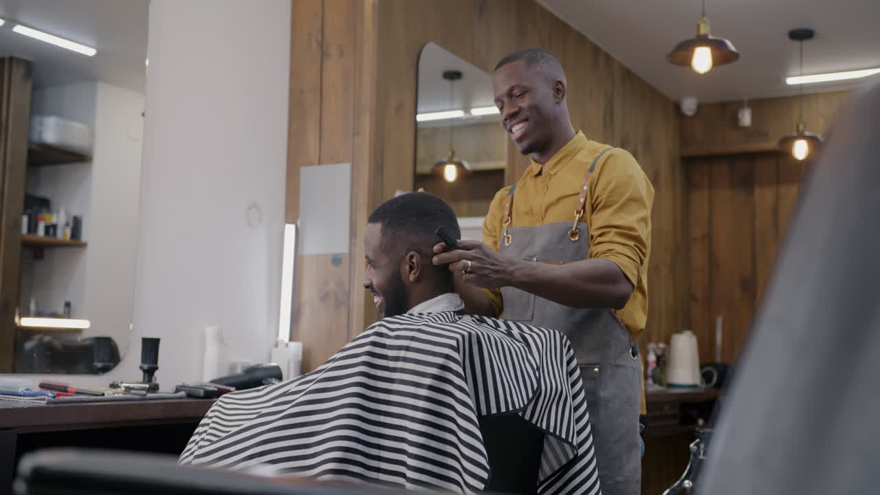 Barber giving a haircut to a customer in a modern barbershop