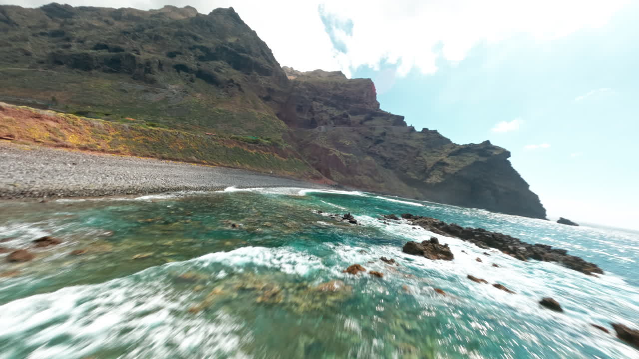 FPV drone over rocky La Palma coast with turquoise sea views